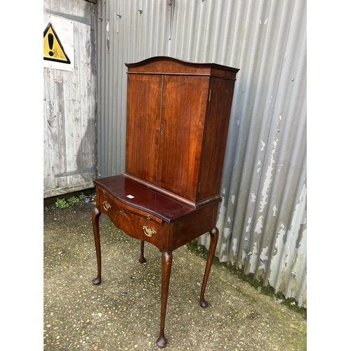 35 - A mahogany two door cuobaord on a single drawer stand