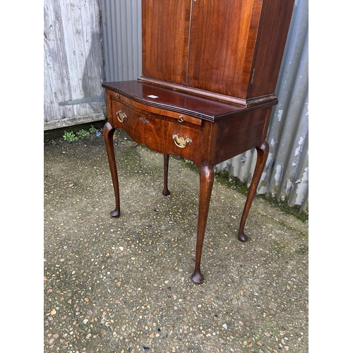 35 - A mahogany two door cuobaord on a single drawer stand