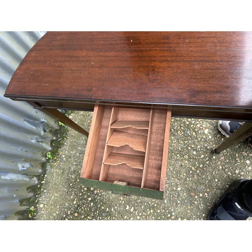 36 - A mahogany demi lune card table with green baize