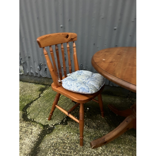 48 - A circular pine table and two chairs 90cm diameter