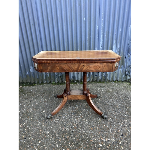 65 - A Victorian mahogany card table with fold over top and green baize playing surface