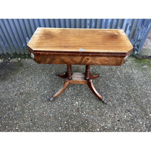 65 - A Victorian mahogany card table with fold over top and green baize playing surface