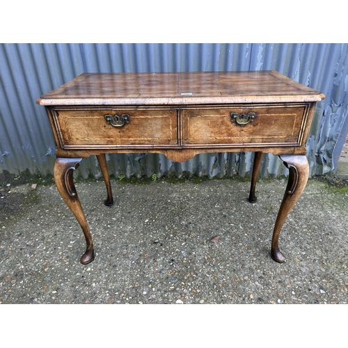 66 - A Georgian walnut two drawer writing table 100x50x80