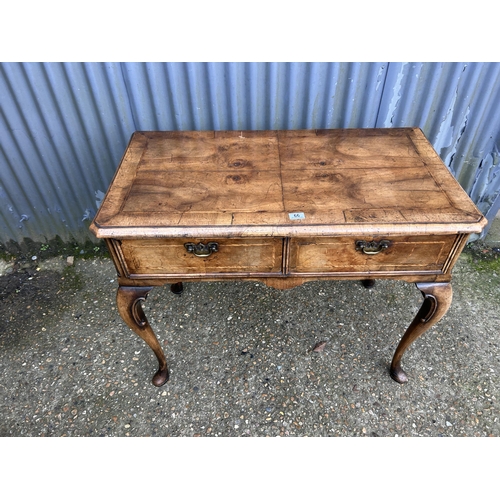 66 - A Georgian walnut two drawer writing table 100x50x80