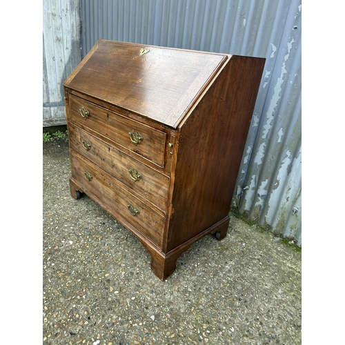 73 - An early victorian mahogany bureau with fitted interior and original Key