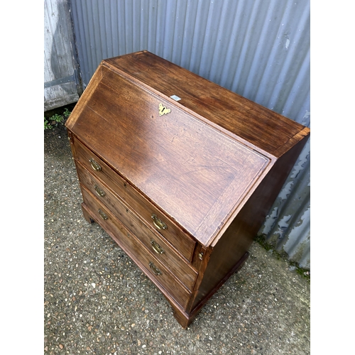 73 - An early victorian mahogany bureau with fitted interior and original Key