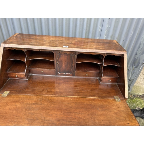 73 - An early victorian mahogany bureau with fitted interior and original Key