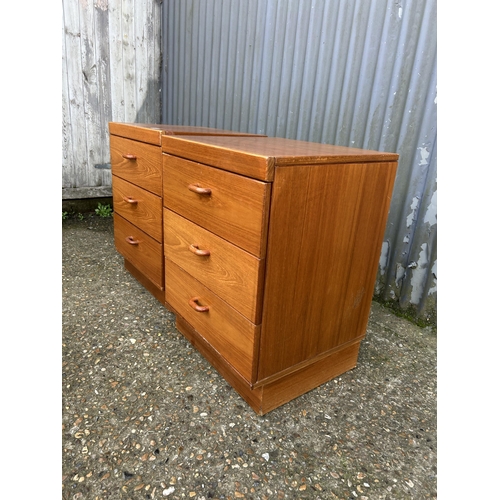 84 - A pair of mid century teak bedside chests of three drawers