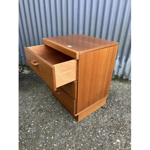 84 - A pair of mid century teak bedside chests of three drawers