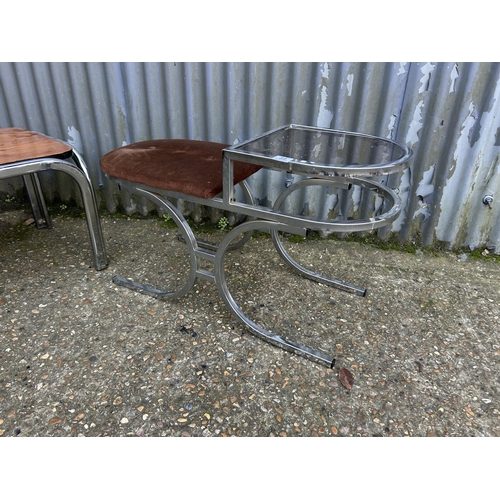 89 - A mid century chrome and smoked glass telephone seat together with a chrome framed coffee table