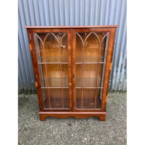 98 - A glazed yew two door display cabinet 93x33x122