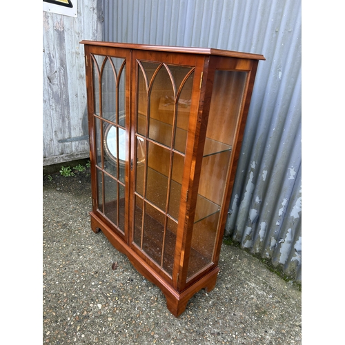 98 - A glazed yew two door display cabinet 93x33x122