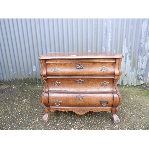 1 - A small oak bombe front cupboard 74 x40x70