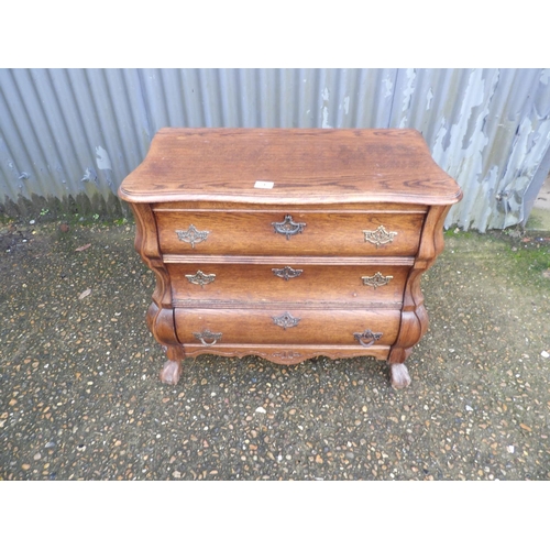 1 - A small oak bombe front cupboard 74 x40x70