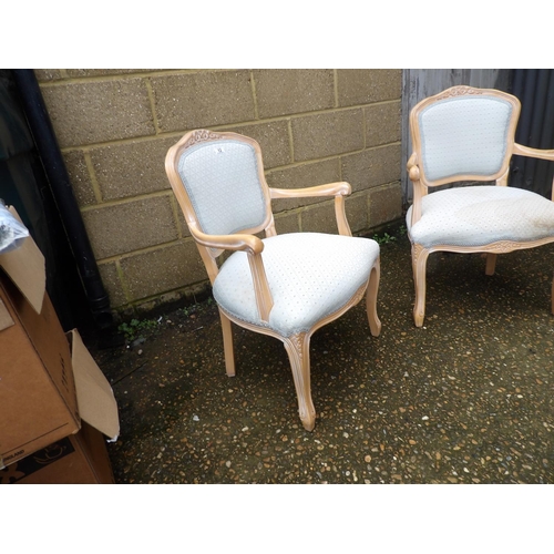 12 - A pair of french style elbow chairs