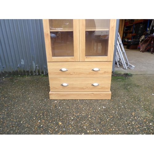 7 - A large modern glazed display cabinet with two drawers 90x48x200