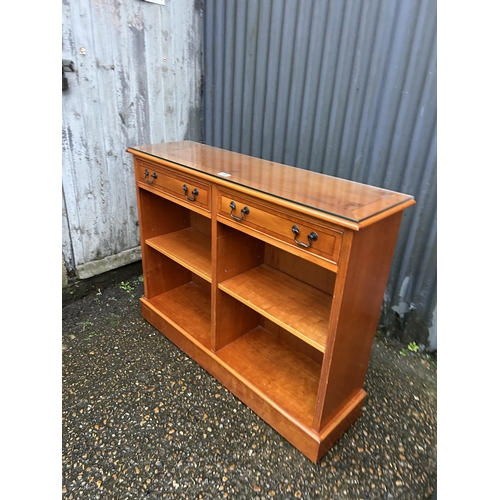 175 - A repro yew wood two drawer open bookcase