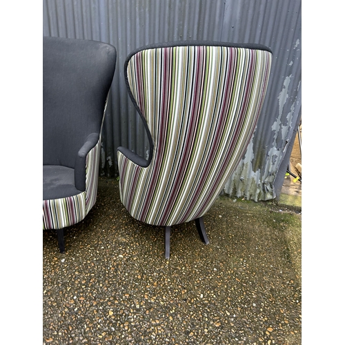 183 - A pair of modern black and striped wing back armchairs