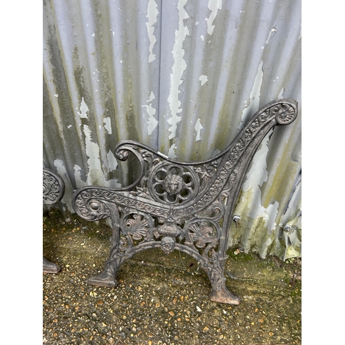 211 - A pair of ornate heavy iron bench ends