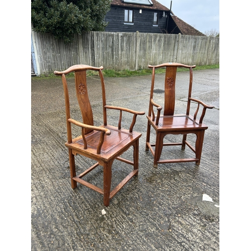 217 - A pair of oriental hardwood carver chairs