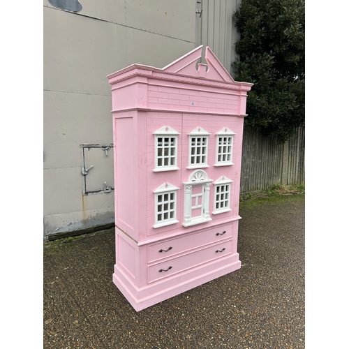 222 - A very large nursery wardrobe styled as a large pink dolls house 125x55x 177