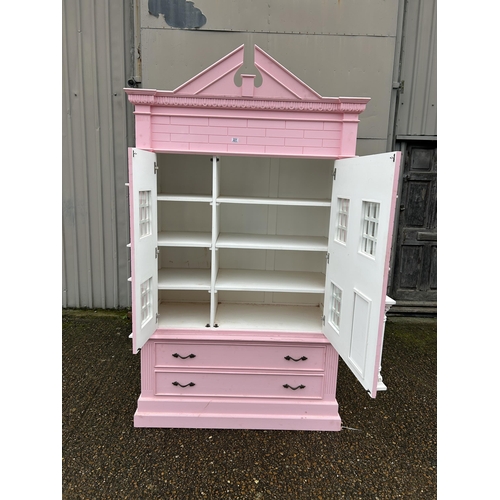 222 - A very large nursery wardrobe styled as a large pink dolls house 125x55x 177