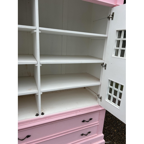 222 - A very large nursery wardrobe styled as a large pink dolls house 125x55x 177