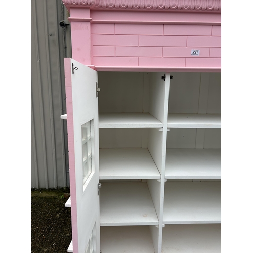 222 - A very large nursery wardrobe styled as a large pink dolls house 125x55x 177