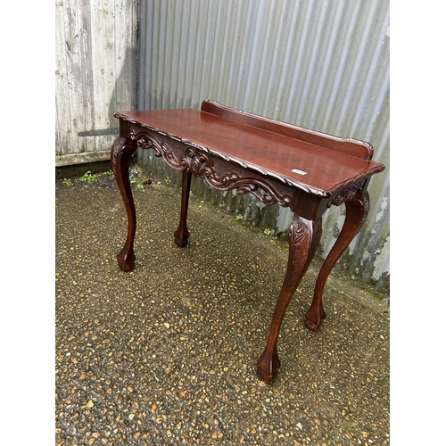 223 - A reproduction mahogany ball and claw side table 92x45 x80