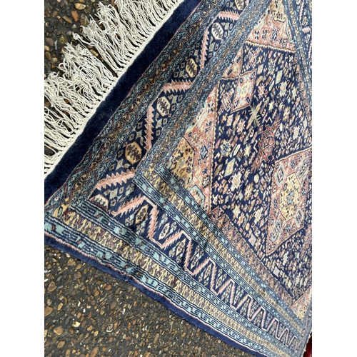 234 - An oriental blue silk rug 130x195