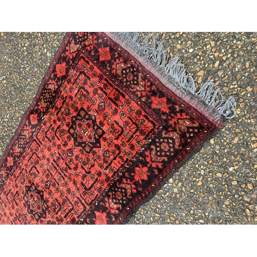 236 - A red and black pattern oriental  runner 290x80