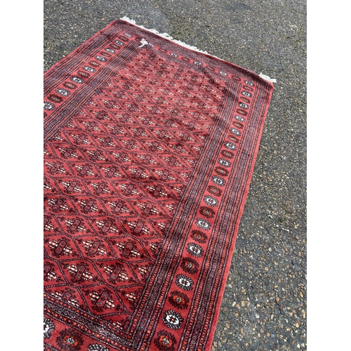 237 - A red and gold pattern rug 130x210