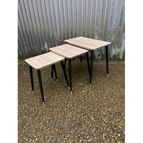 242 - A retro formica nest of three occasional tables