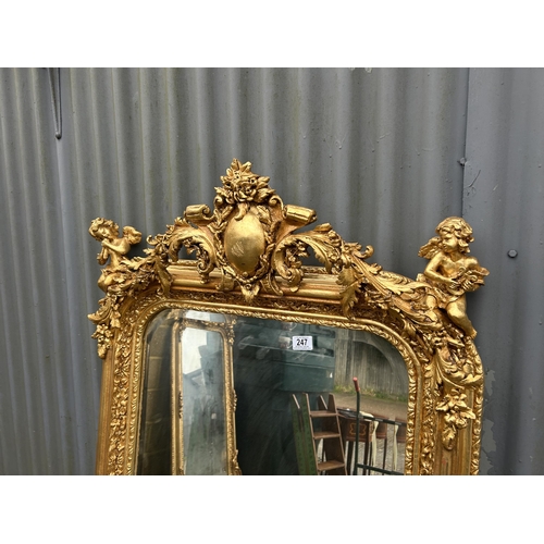 247 - An ornate gold gilt framed mirror with cherub decoration 80x160