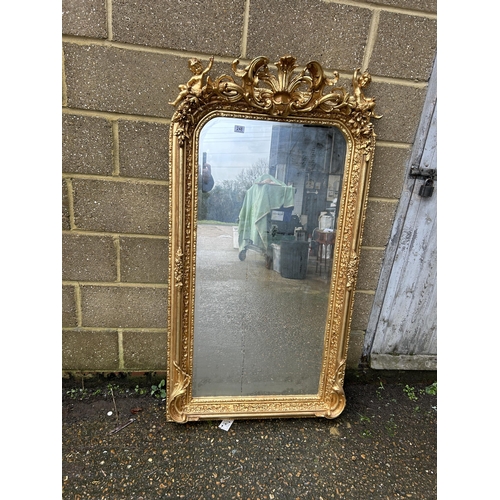 248 - An ornate gold gilt framed mirror with cherub decoration 80x161