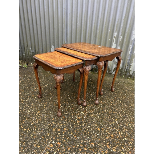 262 - A walnut nest of three occasional tables