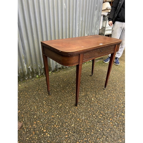 266 - A Victorian mahogany fold over card table with green baize playing surface