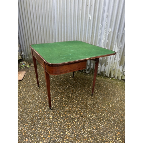 266 - A Victorian mahogany fold over card table with green baize playing surface