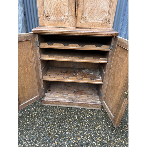 267 - An unusual aesthetic style oak cupboard carved to the front, converted to drinks storage  74 x50x130