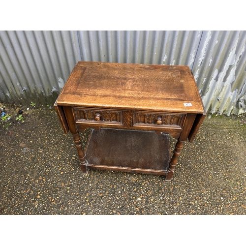 277 - An oak single drawer side table with drop leaf