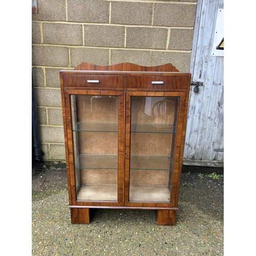 28 - An art deco display cabinet with two drawers and two glazed shelves 88x30x130