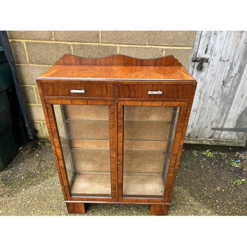 28 - An art deco display cabinet with two drawers and two glazed shelves 88x30x130