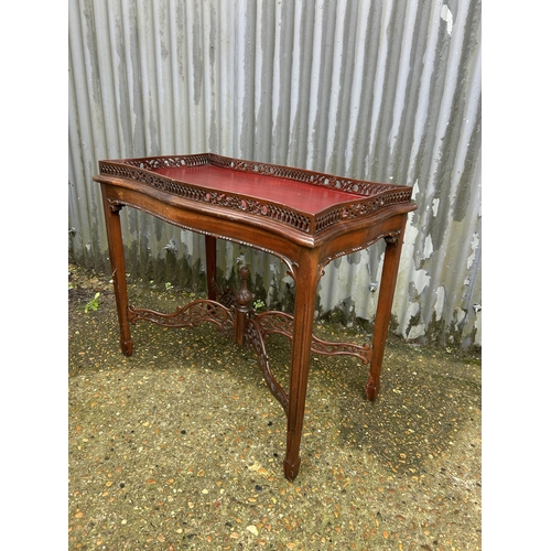 29 - An ornate mahogany occasional table with gallery top 86x46x75