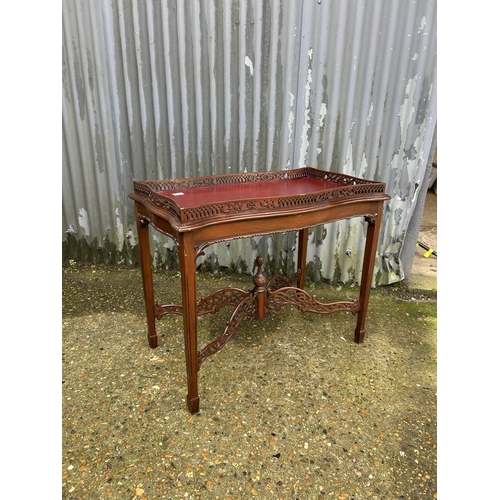 29 - An ornate mahogany occasional table with gallery top 86x46x75