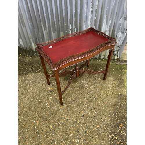 29 - An ornate mahogany occasional table with gallery top 86x46x75