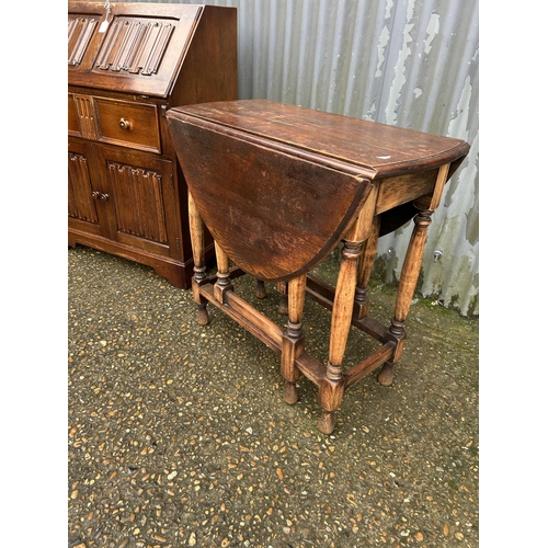 306 - An old charm style oak bureau together with an oak gateleg table