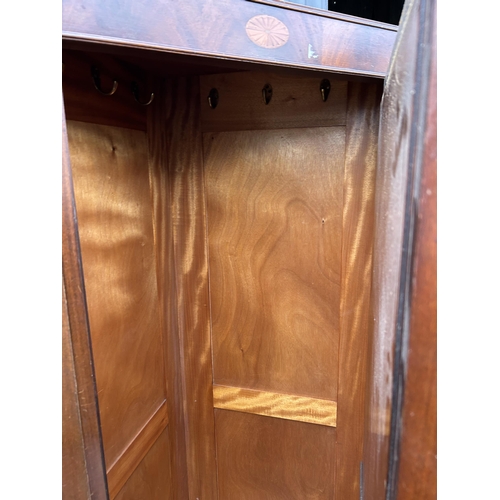 308 - An Edwardian mahogany inlaid single door corner wardrobe