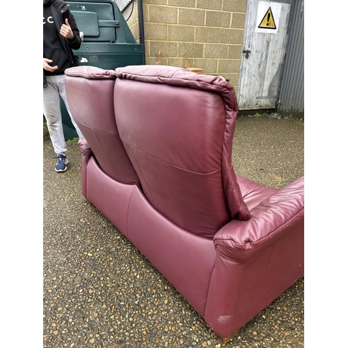 311 - A EKORNES stressless maroon leather two seater sofa