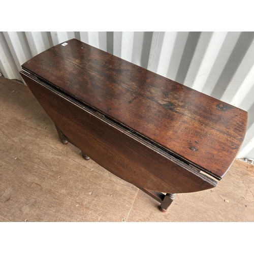 313 - An antique oak gate leg table