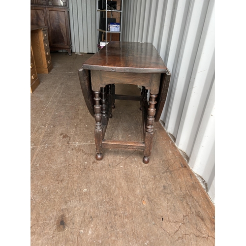 313 - An antique oak gate leg table